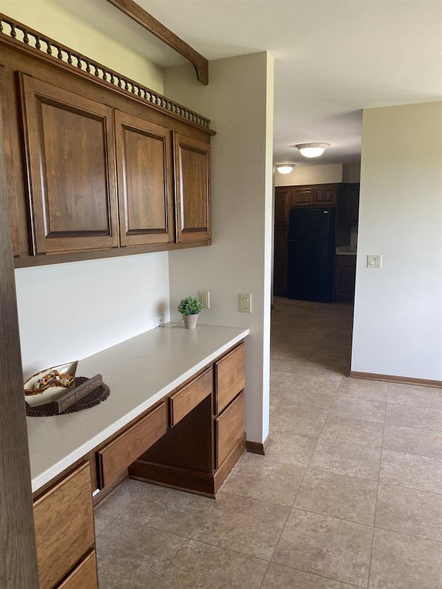 5572 Stable View Ln, Fitchburg, WI 53575 - kitchen with freestanding refrigerator, light countertops, and light tile patterned floors