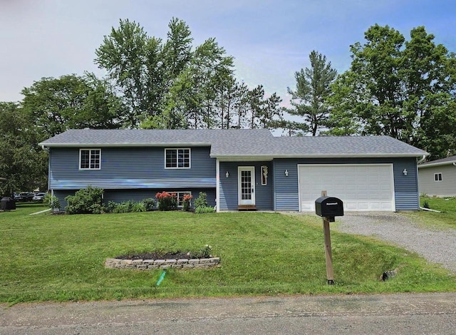 1209 E 15th St, Marshfield, WI 54449 - split level home featuring gravel driveway, a front lawn, and an attached garage