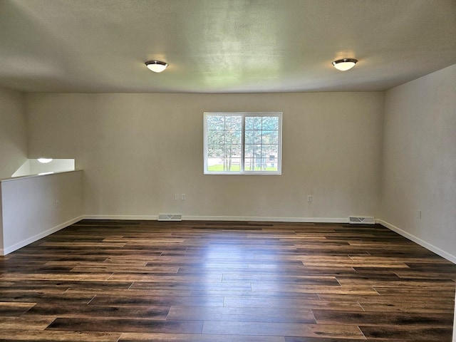 1209 E 15th St, Marshfield, WI 54449 - unfurnished room featuring dark wood-style floors and baseboards