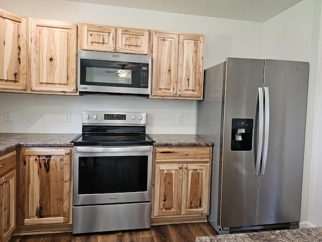1209 E 15th St, Marshfield, WI 54449 - kitchen featuring appliances with stainless steel finishes, dark countertops, dark wood-style floors, and light brown cabinetry