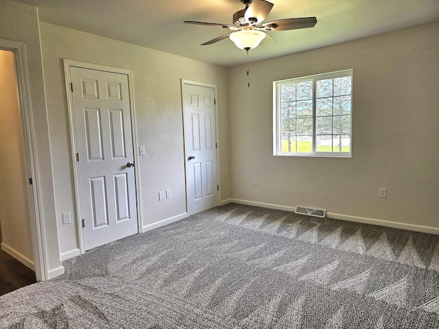 1209 E 15th St, Marshfield, WI 54449 - unfurnished bedroom with dark colored carpet and ceiling fan