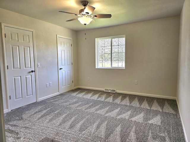 1209 E 15th St, Marshfield, WI 54449 - unfurnished bedroom with dark carpet and ceiling fan