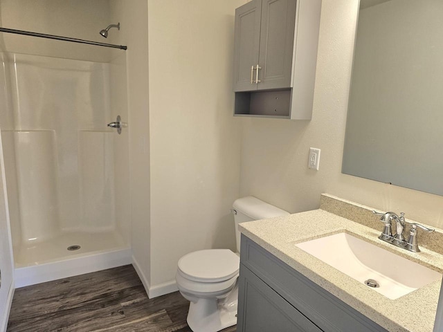 1209 E 15th St, Marshfield, WI 54449 - full bathroom with wood finished floors, vanity, and a shower