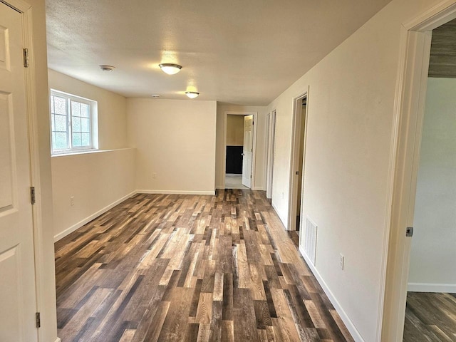 1209 E 15th St, Marshfield, WI 54449 - spare room featuring dark wood-style floors and baseboards