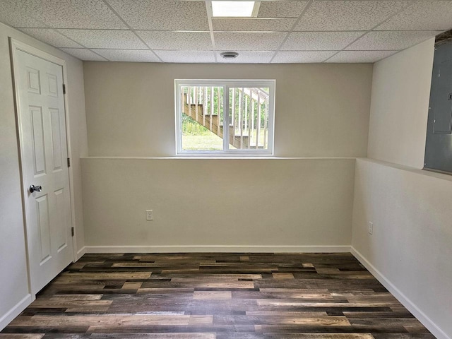 1209 E 15th St, Marshfield, WI 54449 - unfurnished room featuring a drop ceiling, dark wood-type flooring, and electric panel
