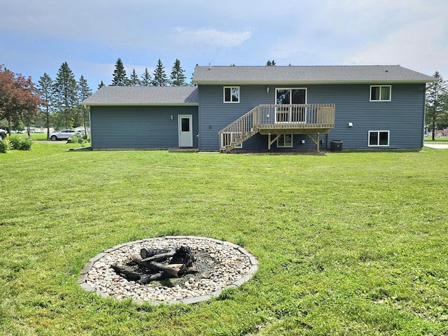 1209 E 15th St, Marshfield, WI 54449 - back of house featuring stairway, an outdoor fire pit, a wooden deck, and a yard