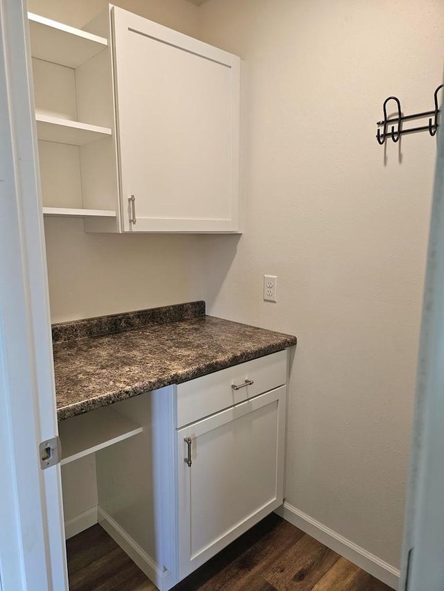 1209 E 15th St, Marshfield, WI 54449 - kitchen featuring dark countertops, dark wood-style floors, open shelves, and white cabinets