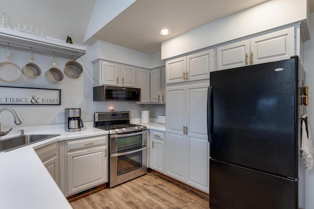 400 Oak St, Argyle, WI 53504 - kitchen with stainless steel appliances, light countertops, light wood finished floors, recessed lighting, and white cabinets