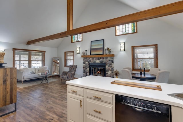400 Oak St, Argyle, WI 53504 - kitchen with black dishwasher, open floor plan, high vaulted ceiling, a stone fireplace, and white cabinets