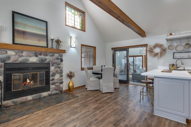 400 Oak St, Argyle, WI 53504 - living area with high vaulted ceiling, a stone fireplace, beam ceiling, and dark wood-style flooring