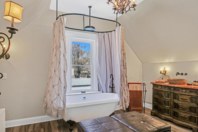 822 12th Ave, Union Grove, WI 53182 - full bathroom featuring a soaking tub, vaulted ceiling, and wood finished floors
