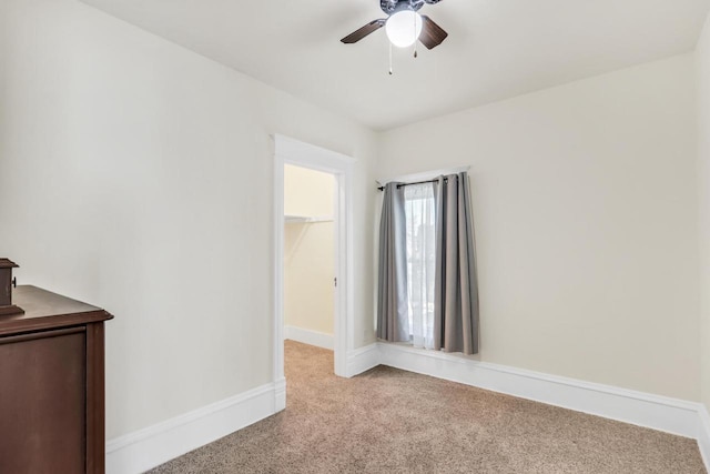 822 12th Ave, Union Grove, WI 53182 - unfurnished bedroom with light colored carpet, a spacious closet, and a ceiling fan