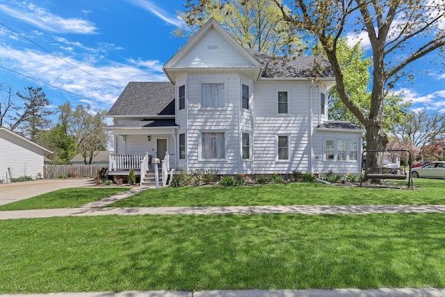 822 12th Ave, Union Grove, WI 53182 - victorian house with a front yard, a shingled roof, and driveway