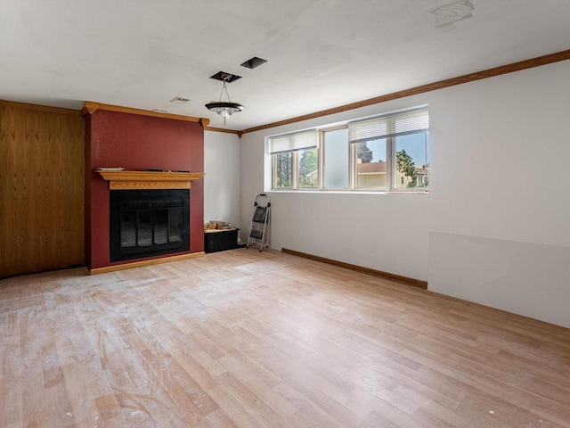 1010 Orchard Dr, Manitowoc, WI 54220 - unfurnished living room featuring ornamental molding, wood finished floors, and a glass covered fireplace