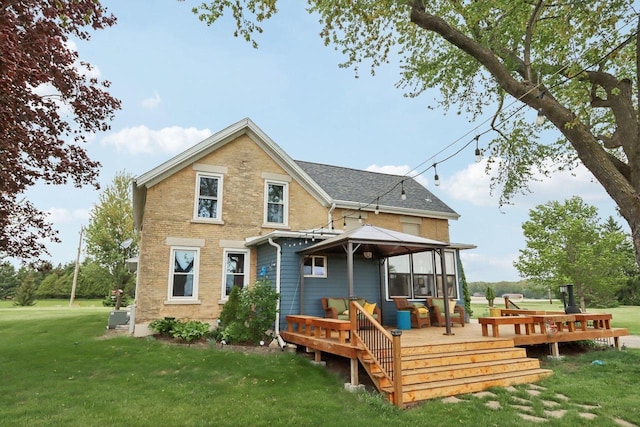 N5562 County Road A, Lake Mills, WI 53551 - back of property featuring a lawn, a deck, a gazebo, and brick siding