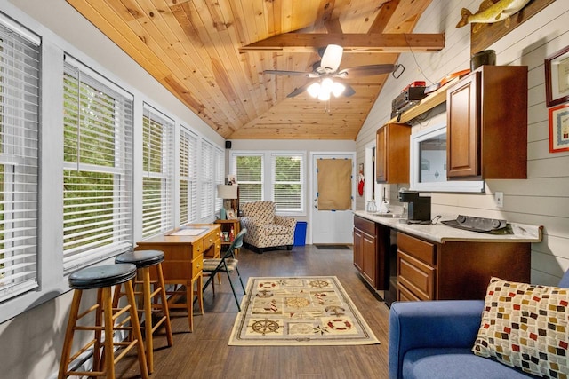 6170 Bay Shore Dr, Sturgeon Bay, WI 54235 - kitchen with wooden ceiling, dark wood-style flooring, brown cabinetry, a ceiling fan, and wood walls
