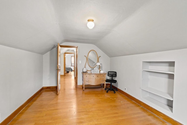 1240 Franklin St, Wisconsin Rapids, WI 54494 - additional living space featuring built in features, light wood-style floors, and vaulted ceiling