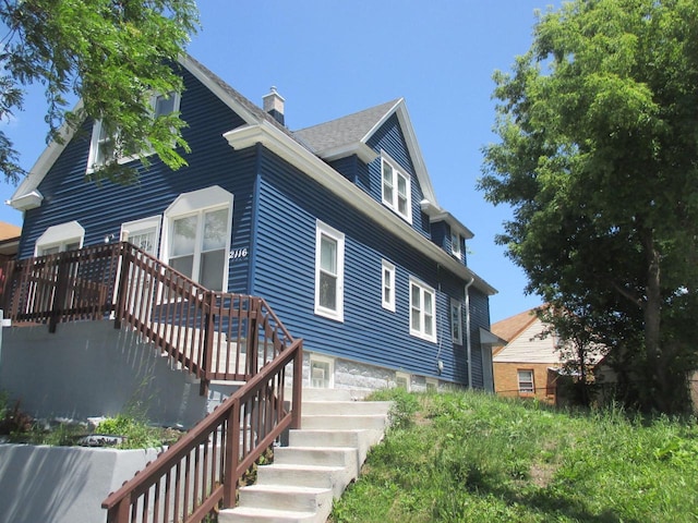 2116 W Atkinson Ave Unit 2116A, Milwaukee, WI 53209 - view of property exterior with a chimney and stairs