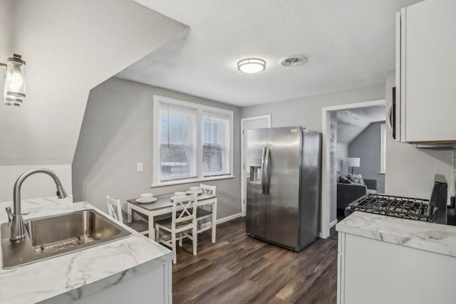 2116 W Atkinson Ave Unit 2116A, Milwaukee, WI 53209 - kitchen with stainless steel fridge, dark wood finished floors, range with gas stovetop, and white cabinets