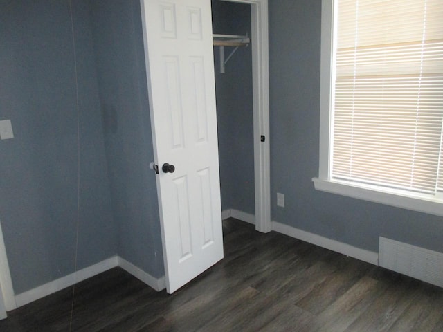 2116 W Atkinson Ave Unit 2116A, Milwaukee, WI 53209 - unfurnished bedroom with dark wood finished floors and a closet