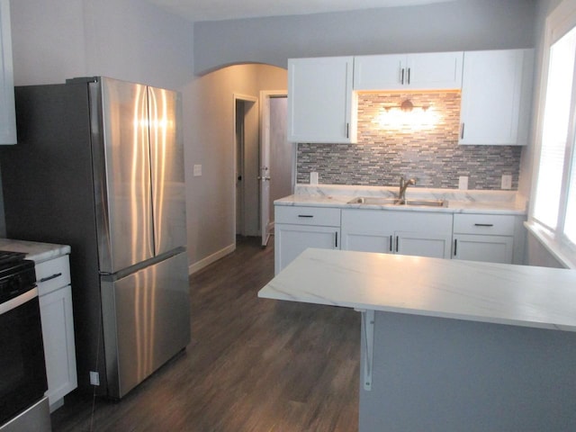 2116 W Atkinson Ave Unit 2116A, Milwaukee, WI 53209 - kitchen with freestanding refrigerator, dark wood finished floors, arched walkways, and white cabinetry
