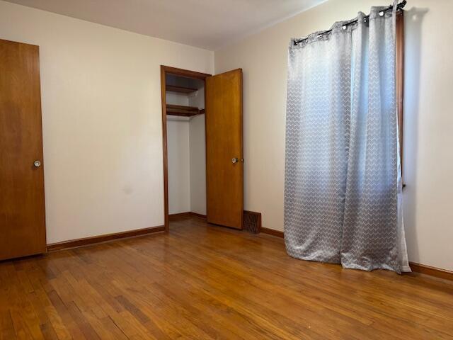 3681 S 5th St, Milwaukee, WI 53207 - unfurnished bedroom featuring wood finished floors and a closet