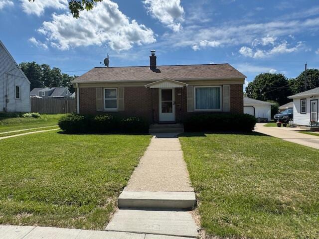 3681 S 5th St, Milwaukee, WI 53207 - bungalow featuring a front yard, brick siding, and a chimney