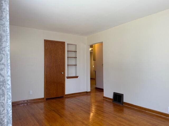 3681 S 5th St, Milwaukee, WI 53207 - empty room with built in features and wood finished floors