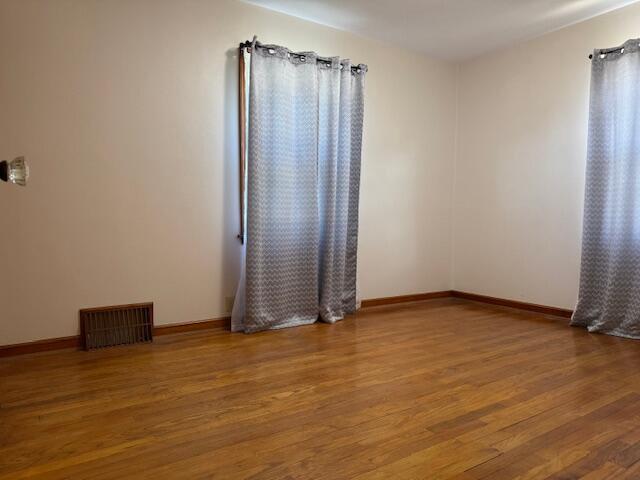 3681 S 5th St, Milwaukee, WI 53207 - spare room featuring wood finished floors and baseboards