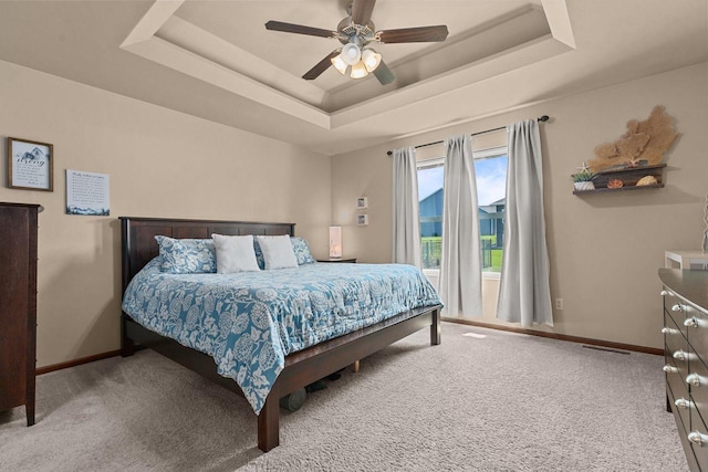 971 Lotus Trl, Menasha, WI 54952 - carpeted bedroom featuring a tray ceiling and ceiling fan