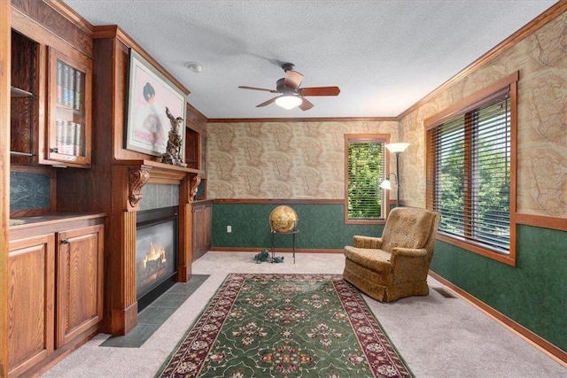 851 174th Ave, New Richmond, WI 54017 - sitting room featuring a tile fireplace, crown molding, carpet flooring, ceiling fan, and a textured ceiling