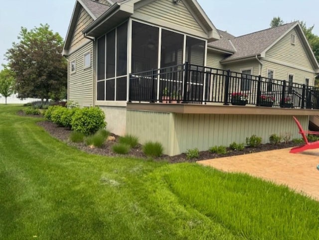 4920 N Meade St, Appleton, WI 54913 - view of property exterior featuring a sunroom, a lawn, and roof with shingles