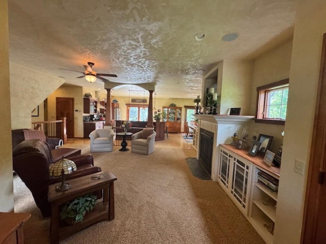 4920 N Meade St, Appleton, WI 54913 - living room with carpet floors, a fireplace with flush hearth, a ceiling fan, and arched walkways