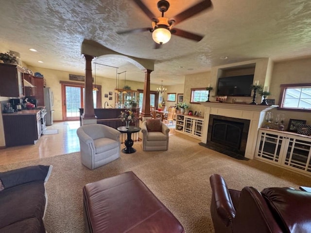 4920 N Meade St, Appleton, WI 54913 - living area with ceiling fan, a chandelier, a textured ceiling, a fireplace with flush hearth, and recessed lighting