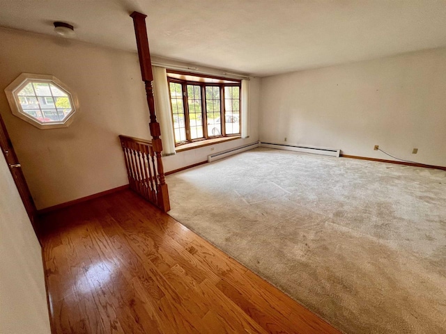 3079 Cornelius Ct, Green Bay, WI 54311 - spare room featuring wood finished floors and a baseboard heating unit