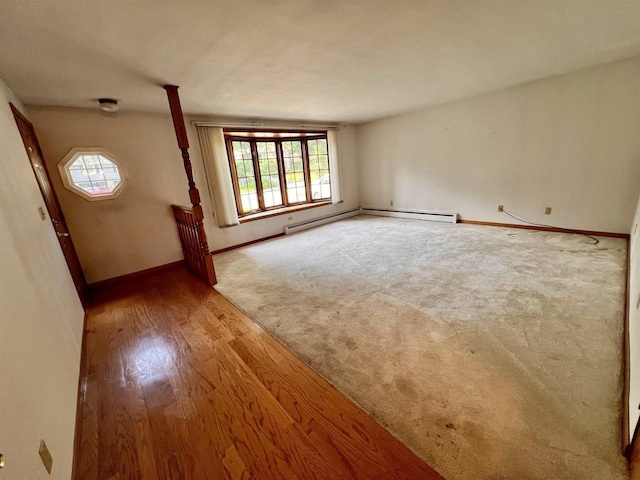 3079 Cornelius Ct, Green Bay, WI 54311 - empty room with plenty of natural light, a baseboard heating unit, and wood finished floors