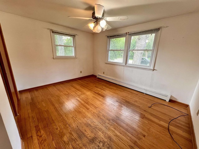 3079 Cornelius Ct, Green Bay, WI 54311 - empty room featuring a baseboard heating unit, light wood finished floors, and a ceiling fan