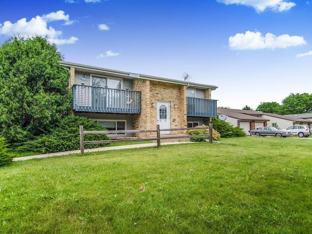521 Seminole Way, Deforest, WI 53532 - view of front of home featuring a front lawn, brick siding, and a balcony