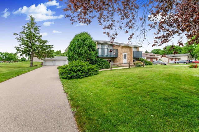 521 Seminole Way, Deforest, WI 53532 - view of front of home with a front lawn, a garage, a balcony, and brick siding