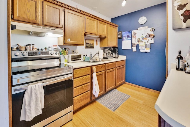 521 Seminole Way, Deforest, WI 53532 - kitchen with stainless steel range with electric cooktop, under cabinet range hood, light wood-type flooring, and light countertops