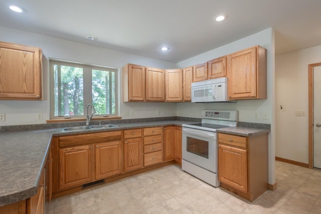 135 E Charles St, Schofield, WI 54476 - kitchen featuring white appliances, dark countertops, and recessed lighting