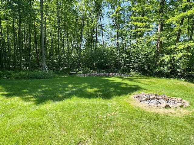 3139 W County Highway D, Sarona, WI 54870 - view of green lawn featuring a fire pit