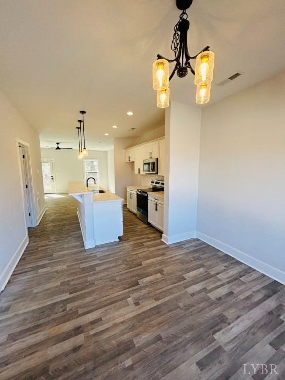 61 Allure Dr, Rustburg, VA 24588 - kitchen featuring open floor plan, white cabinetry, dark wood-type flooring, stainless steel appliances, and a sink
