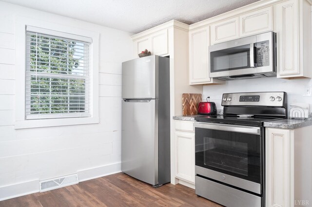 7505 Timberlake Rd, Lynchburg, VA 24502 - kitchen featuring appliances with stainless steel finishes, dark wood-type flooring, and baseboards