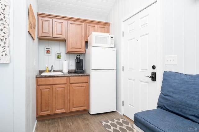 7505 Timberlake Rd, Lynchburg, VA 24502 - kitchen featuring white appliances, wood finished floors, a sink, and dark stone countertops