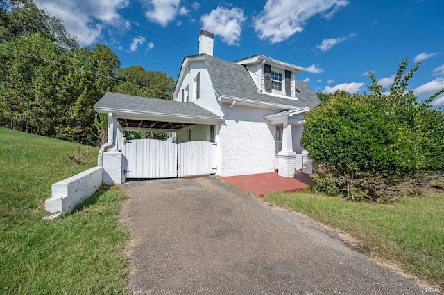 7505 Timberlake Rd, Lynchburg, VA 24502 - view of front of home with a gate, driveway, a shingled roof, a chimney, and a front lawn