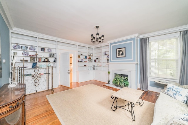 7821 Bellevue Rd, Forest, VA 24551 - living room with built in shelves, hardwood / wood-style floors, a chandelier, and ornamental molding