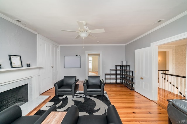 7821 Bellevue Rd, Forest, VA 24551 - living room with a high end fireplace, light wood-type flooring, ceiling fan, and ornamental molding