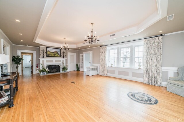 7821 Bellevue Rd, Forest, VA 24551 - living room featuring a raised ceiling, light wood-type flooring, ornamental molding, and a chandelier