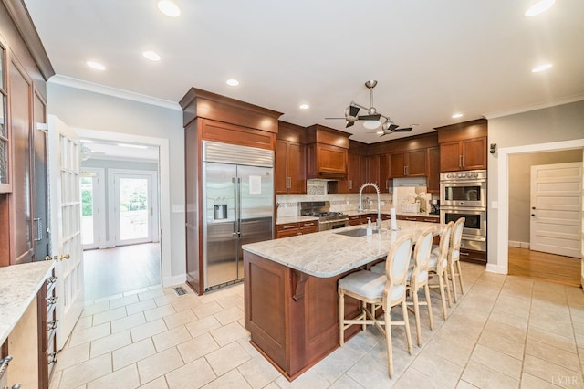 7821 Bellevue Rd, Forest, VA 24551 - kitchen with appliances with stainless steel finishes, tasteful backsplash, light stone counters, sink, and a center island with sink